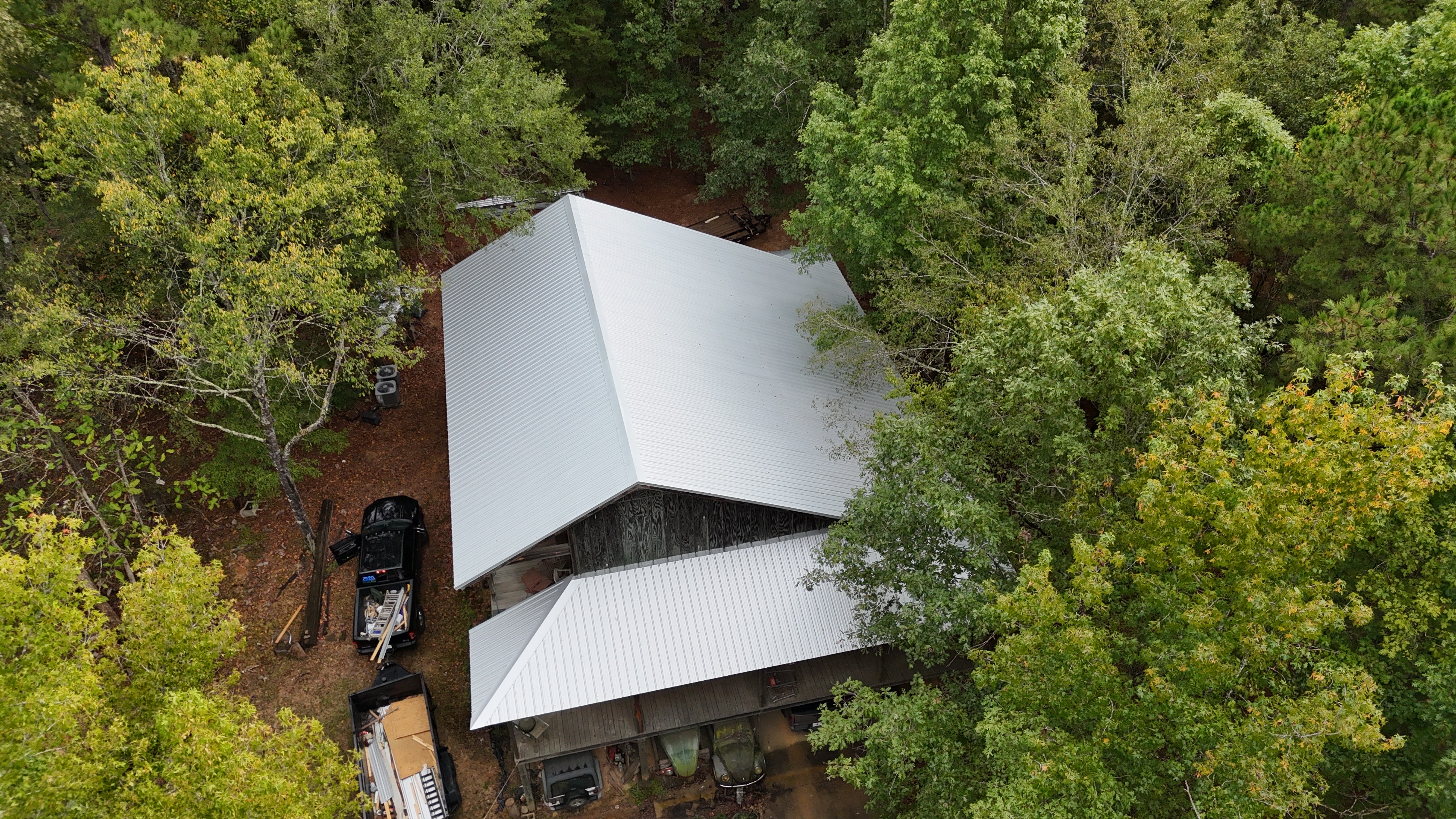 Aerial view of metal roofing on a barn and adjoining covered area